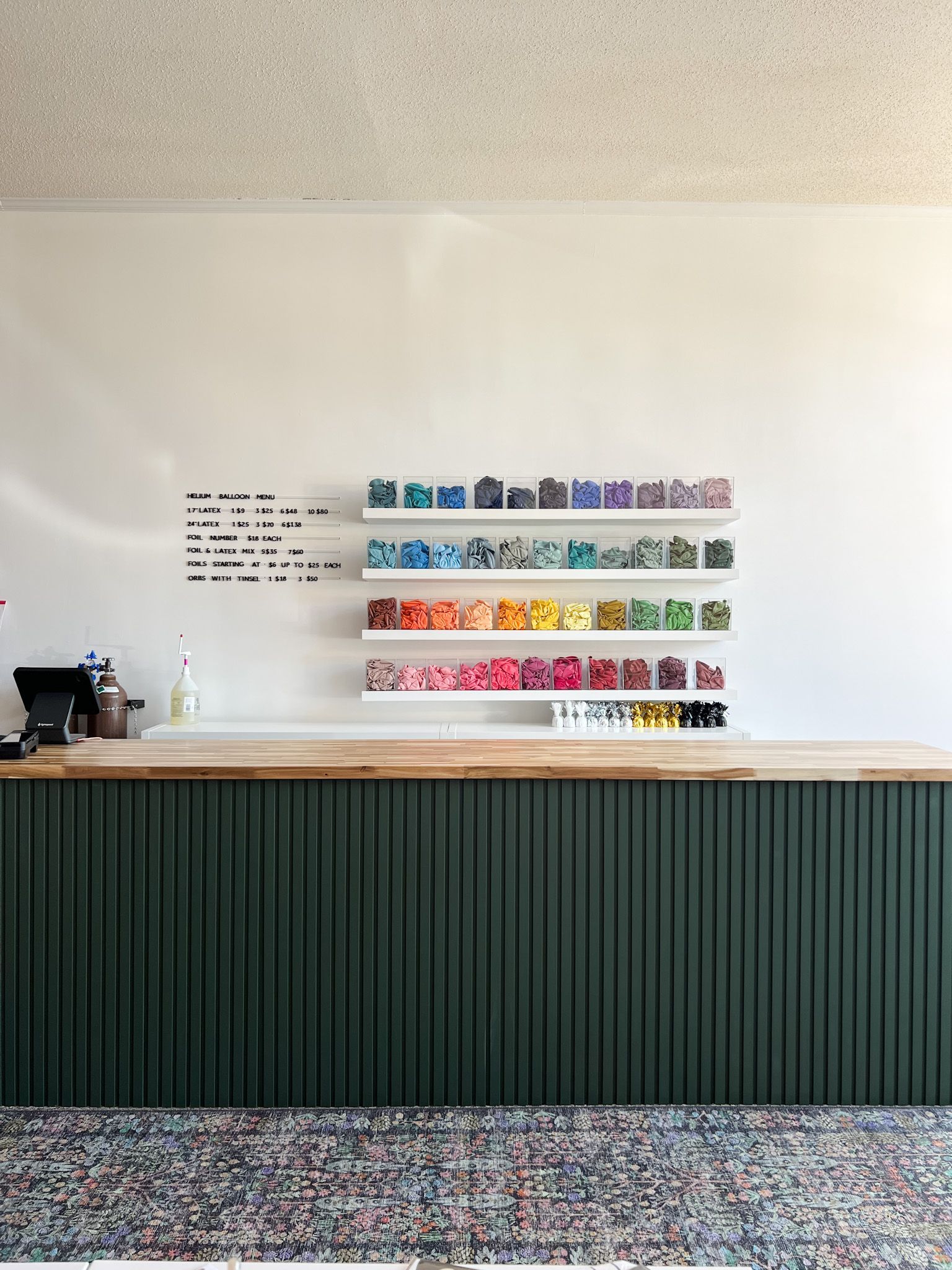 A bunch of balloons are stacked on top of each other in a room.