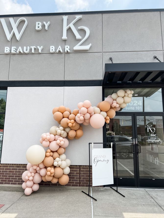 a beauty bar with balloons in front of it