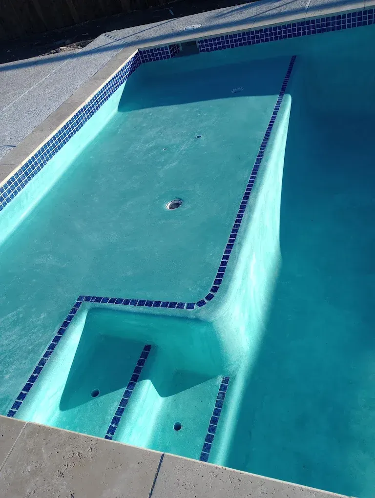 A large swimming pool with stairs leading up to it