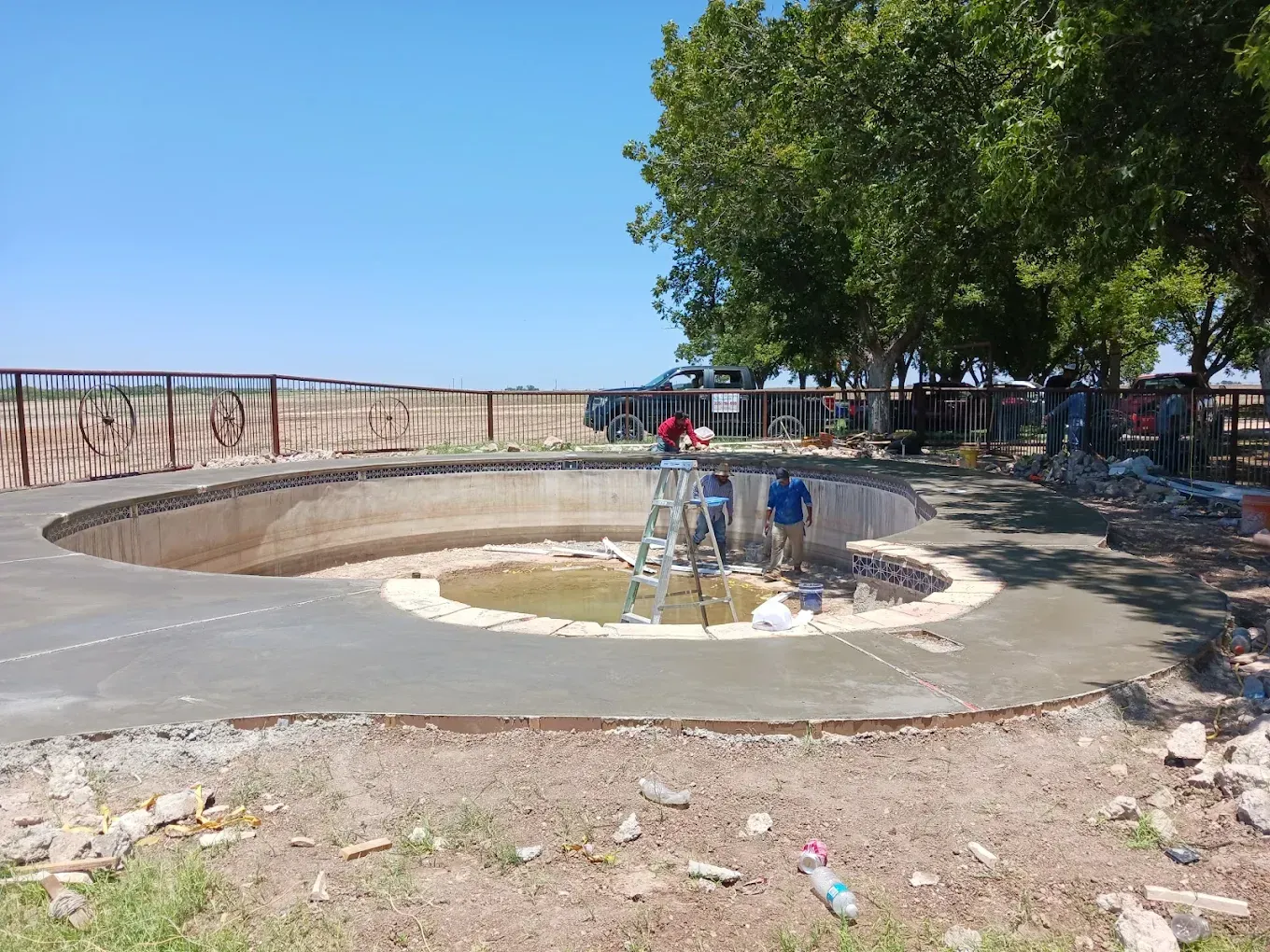 A group of people are working on a swimming pool.