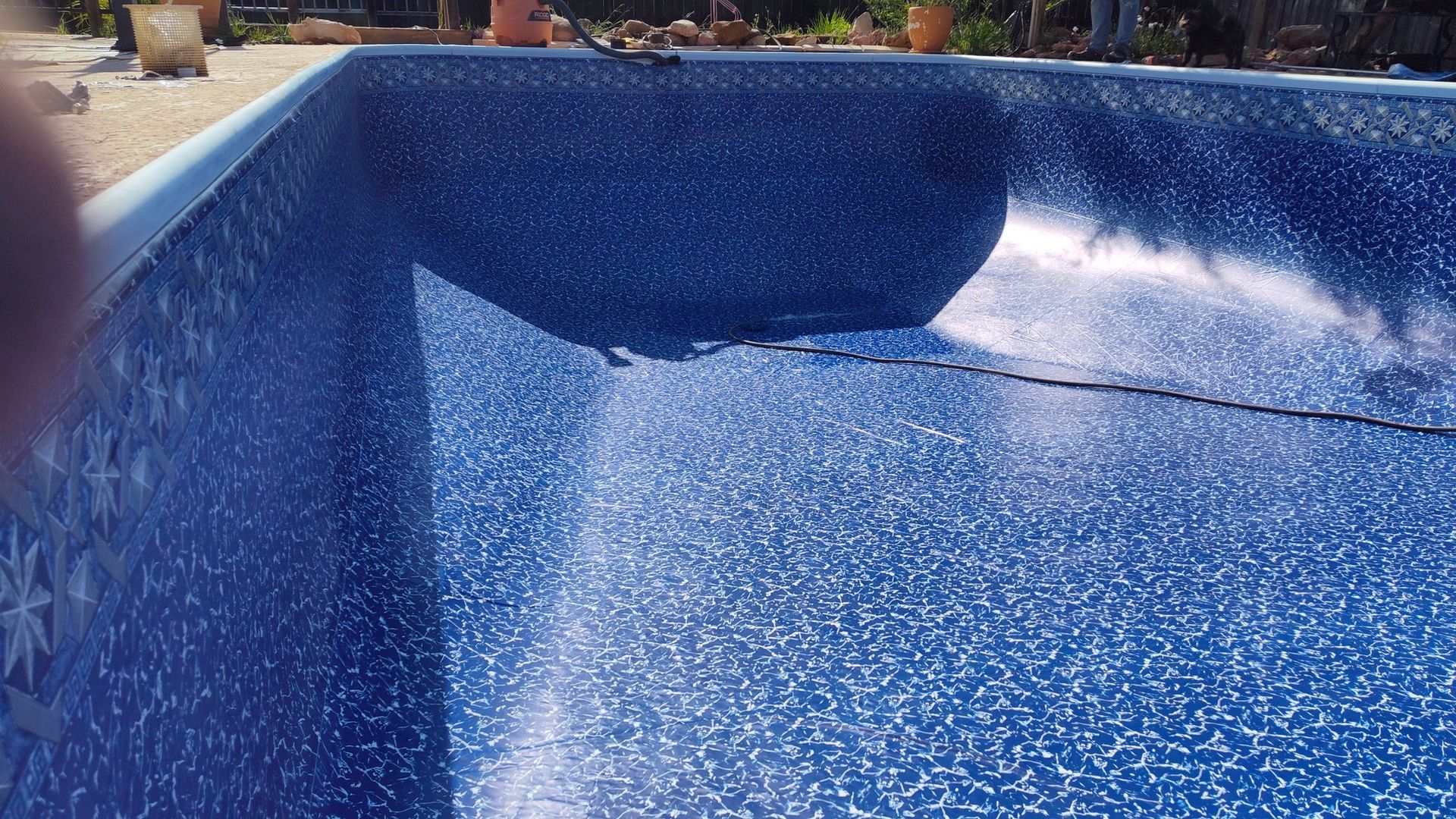A swimming pool with a blue tile bottom