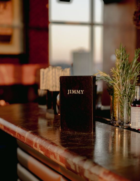 A book called jimmy is sitting on a bar.