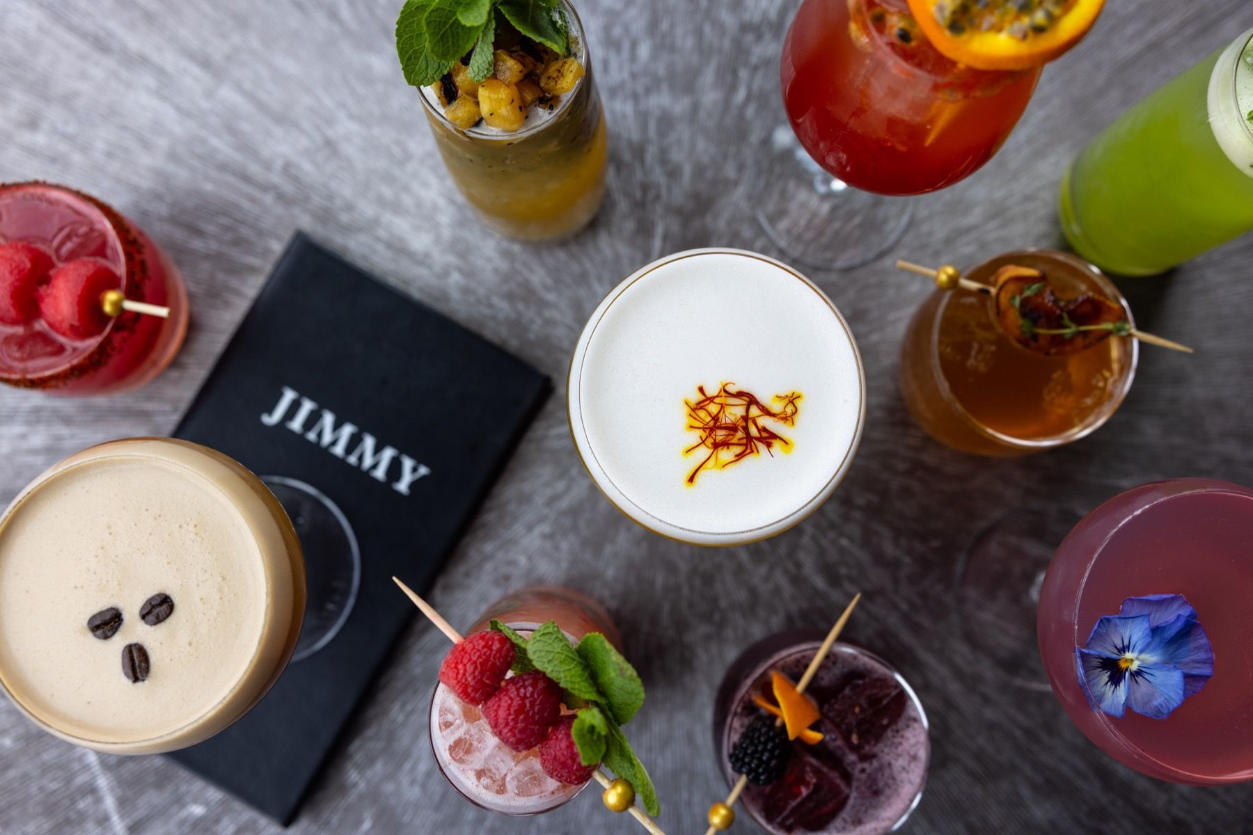 A table topped with a variety of drinks and a menu.