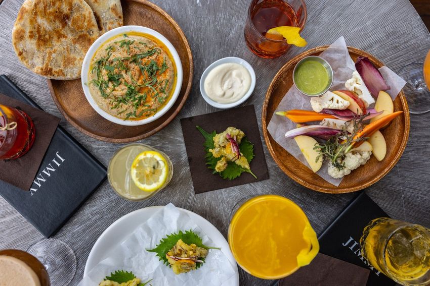 A table topped with bowls of food and drinks.