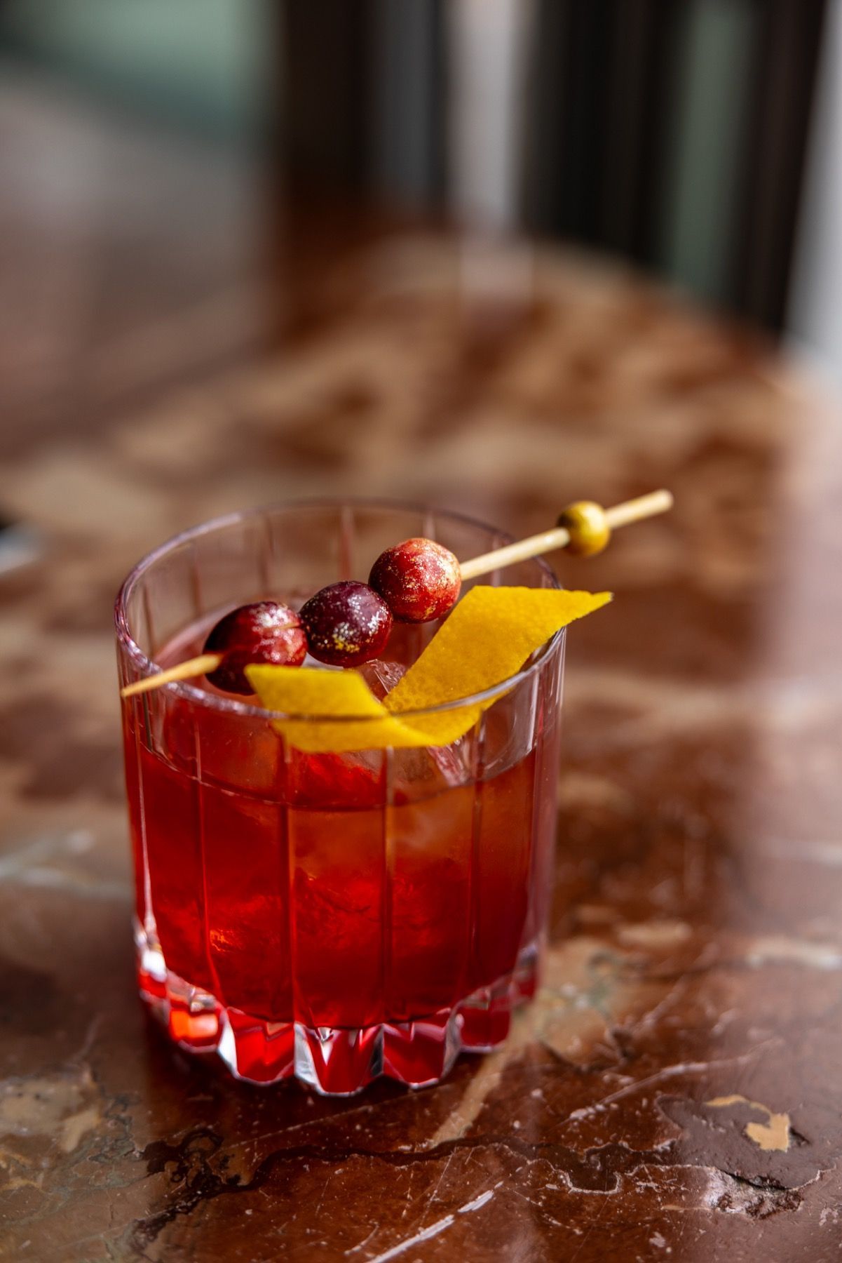 A close up of a drink in a glass on a table.