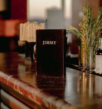 A black book called jimmy is sitting on a counter.