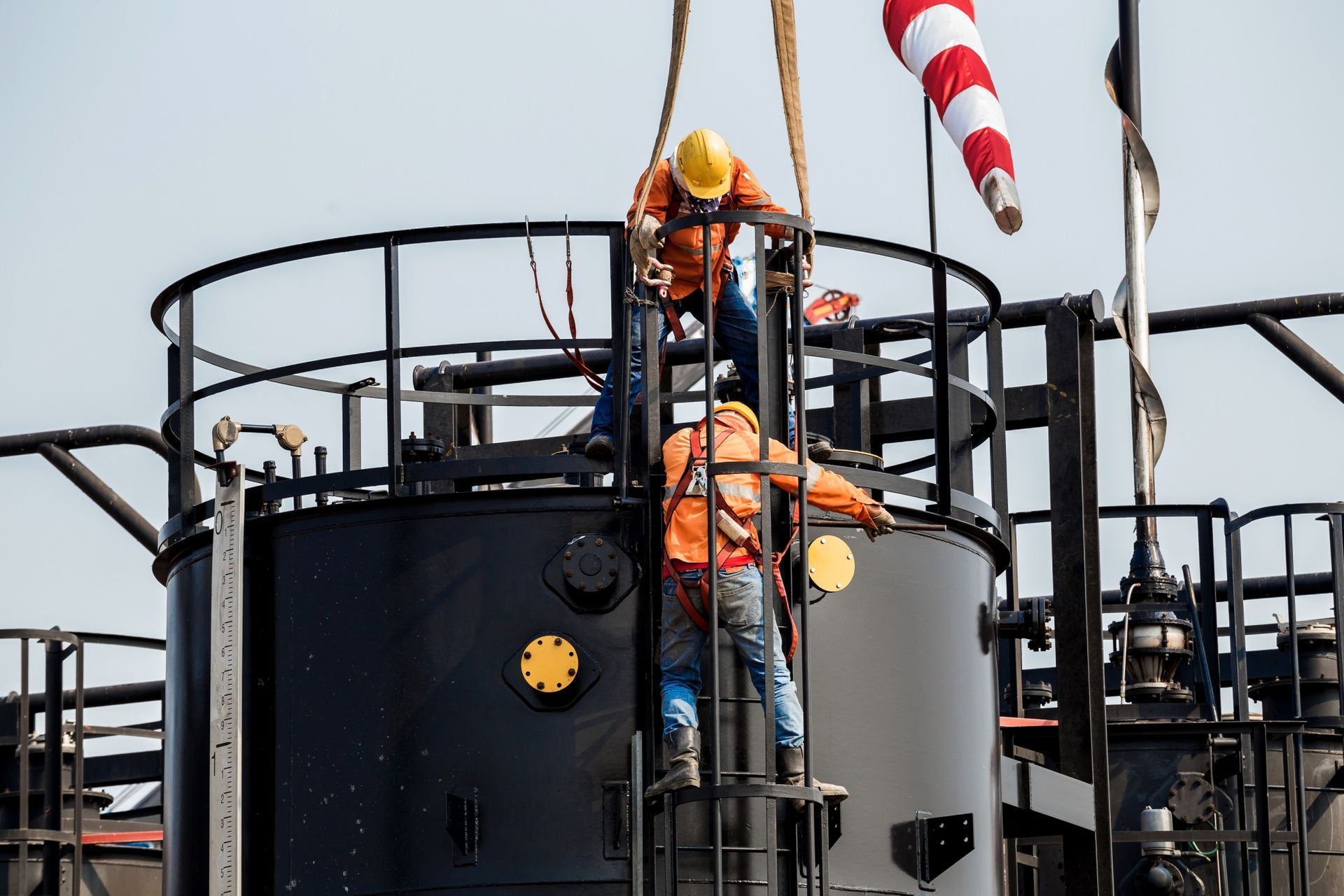 A couple of men are working on a large structure.