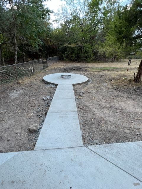 concrete pathway to firepit built by pro roofing and construction
