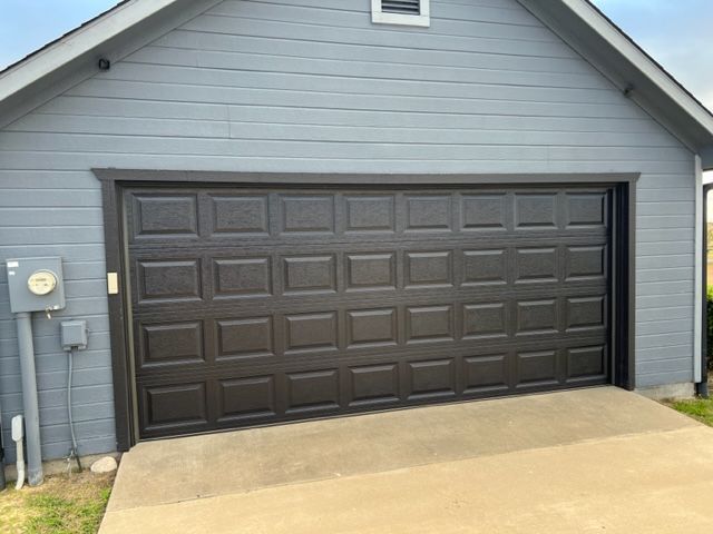 metal garage door replaced by pro roofing and construction