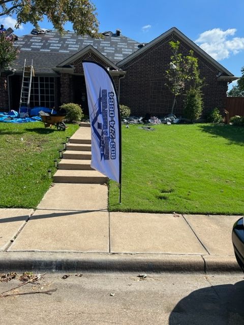 banner sign for pro roofing and construction after replacing roof due to storms