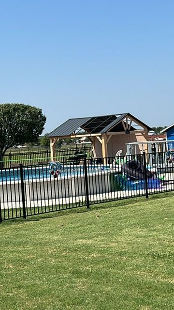 custom fence and concrete slab built around pool for safety