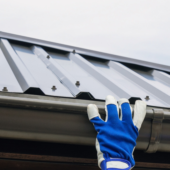 pro roofing and construction gray gutter installation