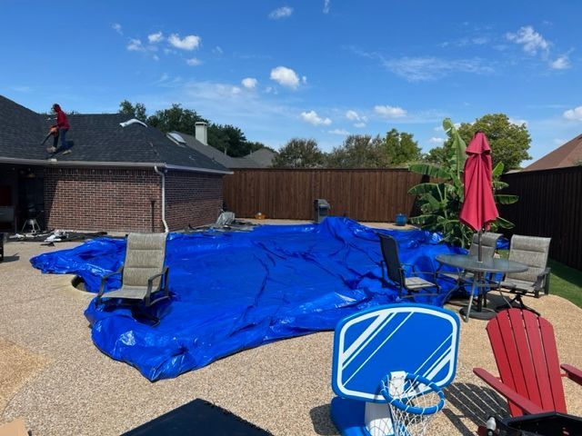 roof replacement by pro roofing and construction and taking care to protect the swimming pool from nails