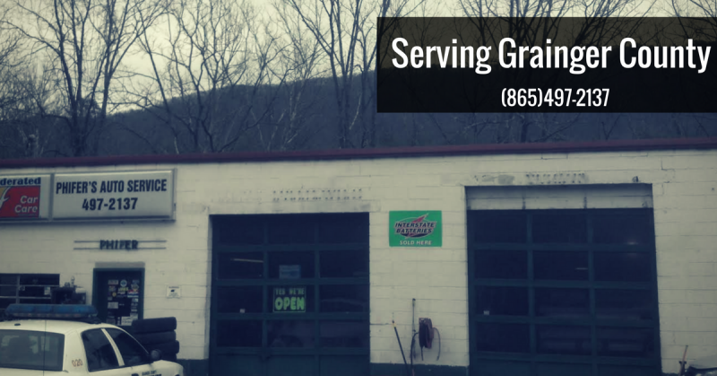 Exterior of Proctor's Auto Service, a garage in Grainger County with two garage doors and text that includes a phone number.