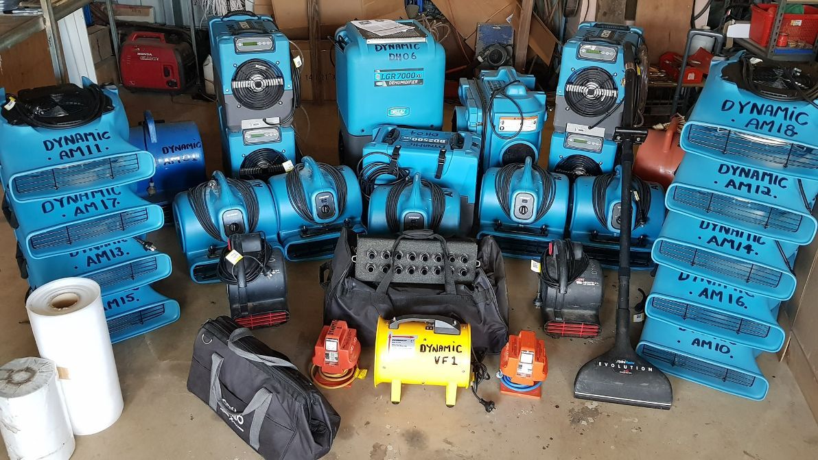A Bunch of Vacuum Cleaners Are Sitting on the Floor in a Garage — Dynamic Services in Limestone Creek, QLD