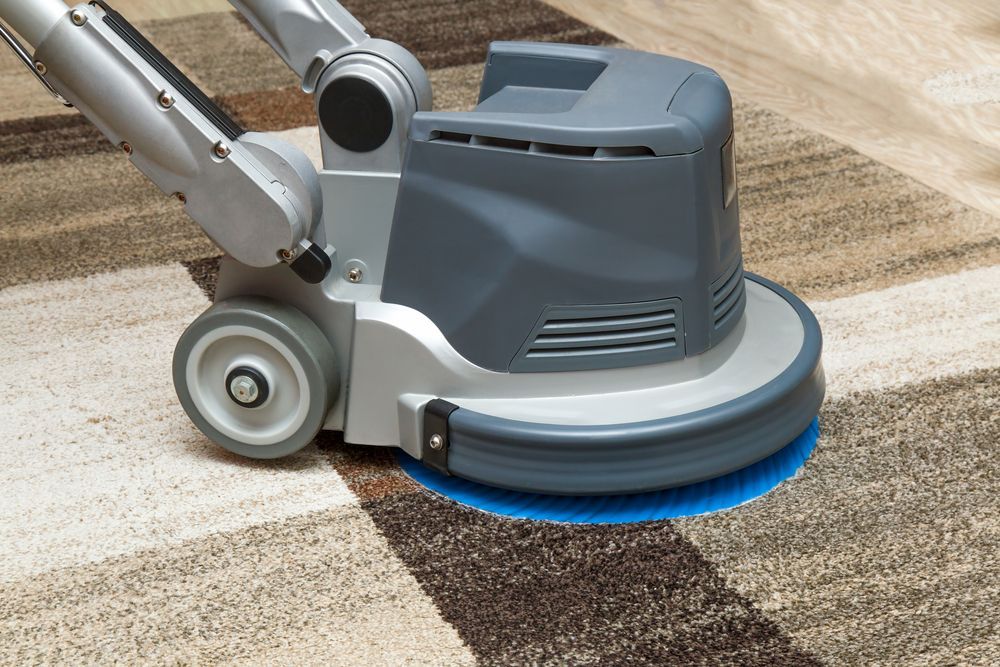 A Machine is Cleaning a Rug on the Floor — Dynamic Services in Biloela, QLD