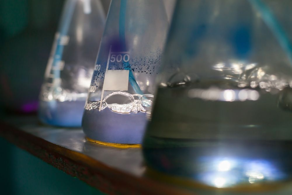 A Row of Beakers Filled With Liquid Are Sitting on a Shelf — Dynamic Services in Limestone Creek, QLD