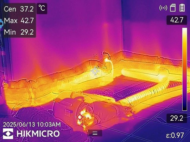 A Person is Holding a Thermal Camera in Their Hand in a Room — Dynamic Services in Limestone Creek, QLD