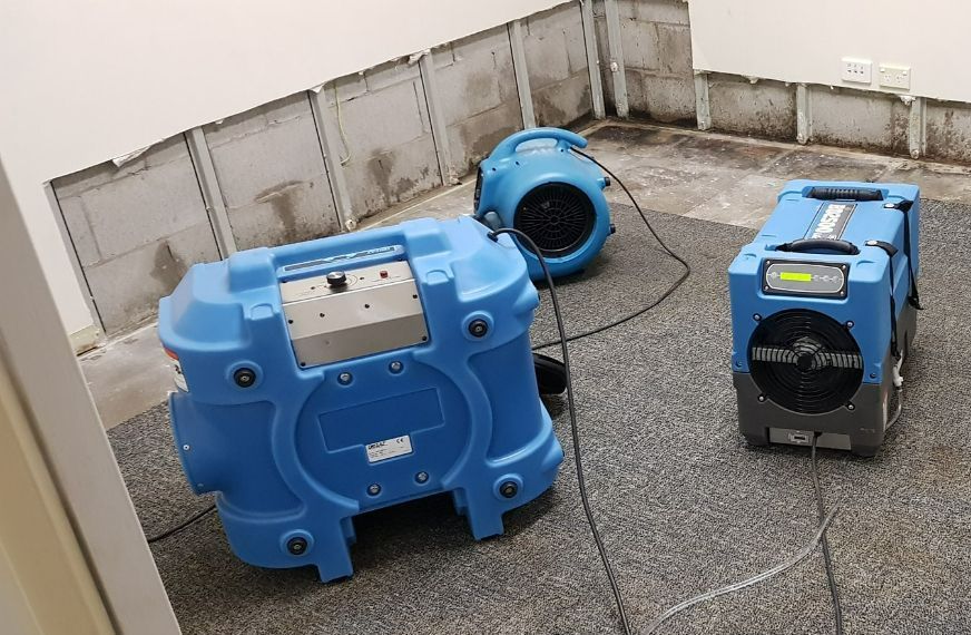 Two Blue Machines Are Sitting on the Floor Next to Each Other — Dynamic Services in Limestone Creek, QLD