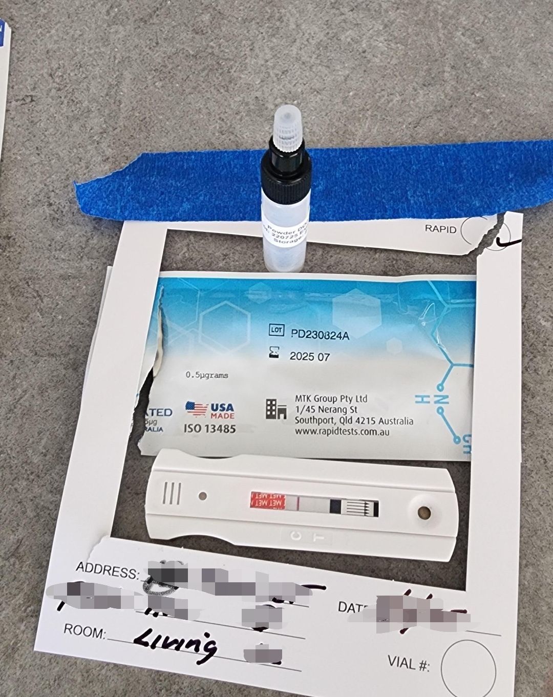 COVID-19 rapid test kit, with test cassette, buffer solution, and instructions on a gray surface.— Dynamic Services in Limestone Creek, QLD