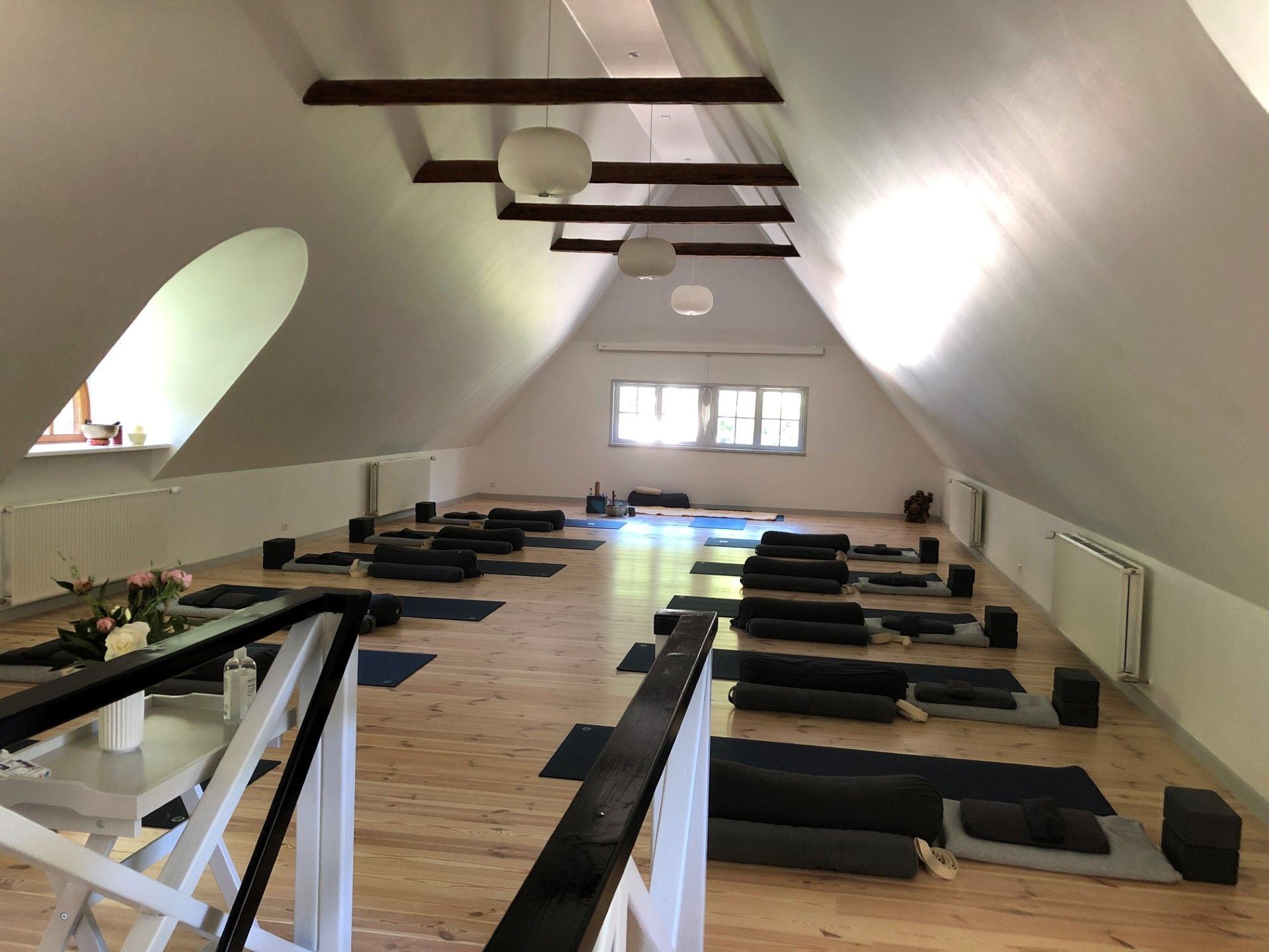 Loftsrum med loft til kip og en masse yogamåtter