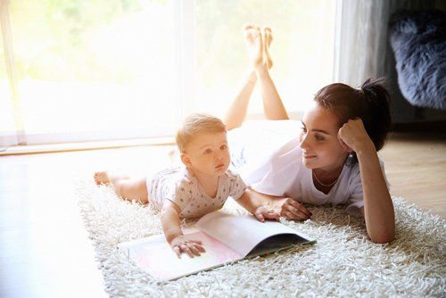 Carpet Cleaning Professional — Mother Reading Book To Her Baby in North Charleston, SC