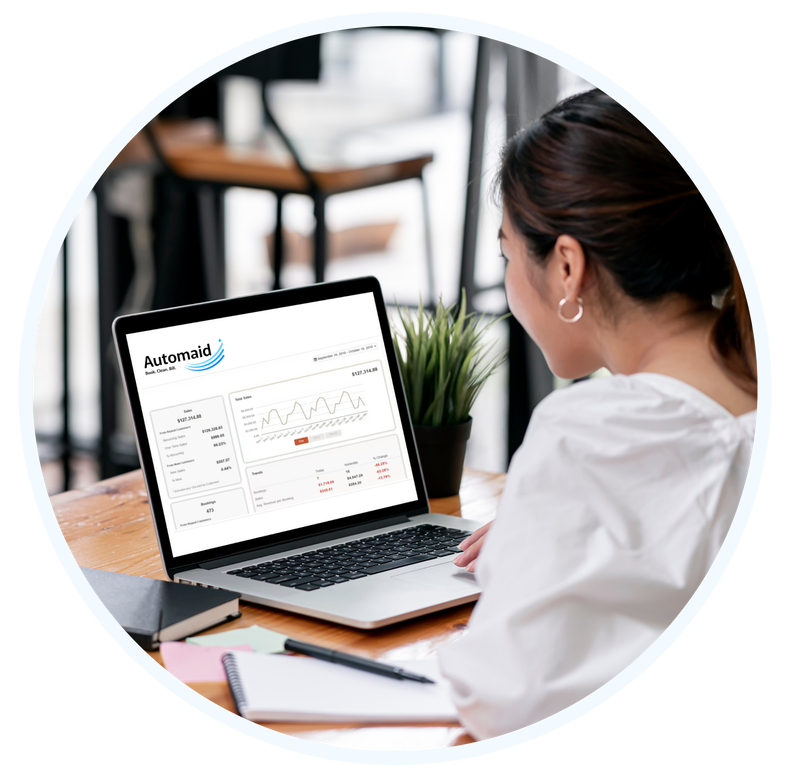 A woman working on a computer uses Automaid to manage her cleaning business.
