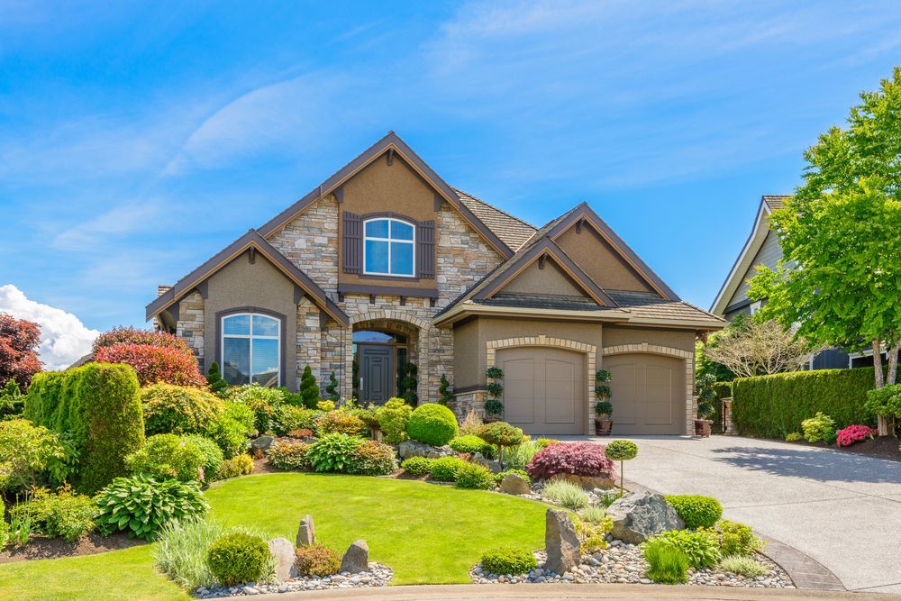 A large house with a lush green lawn in front of it.