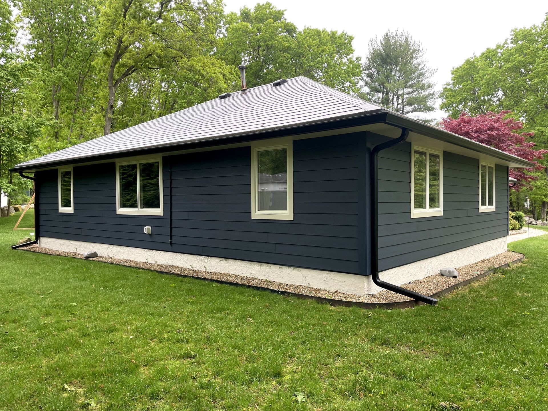A brick house with a roof and a window.
