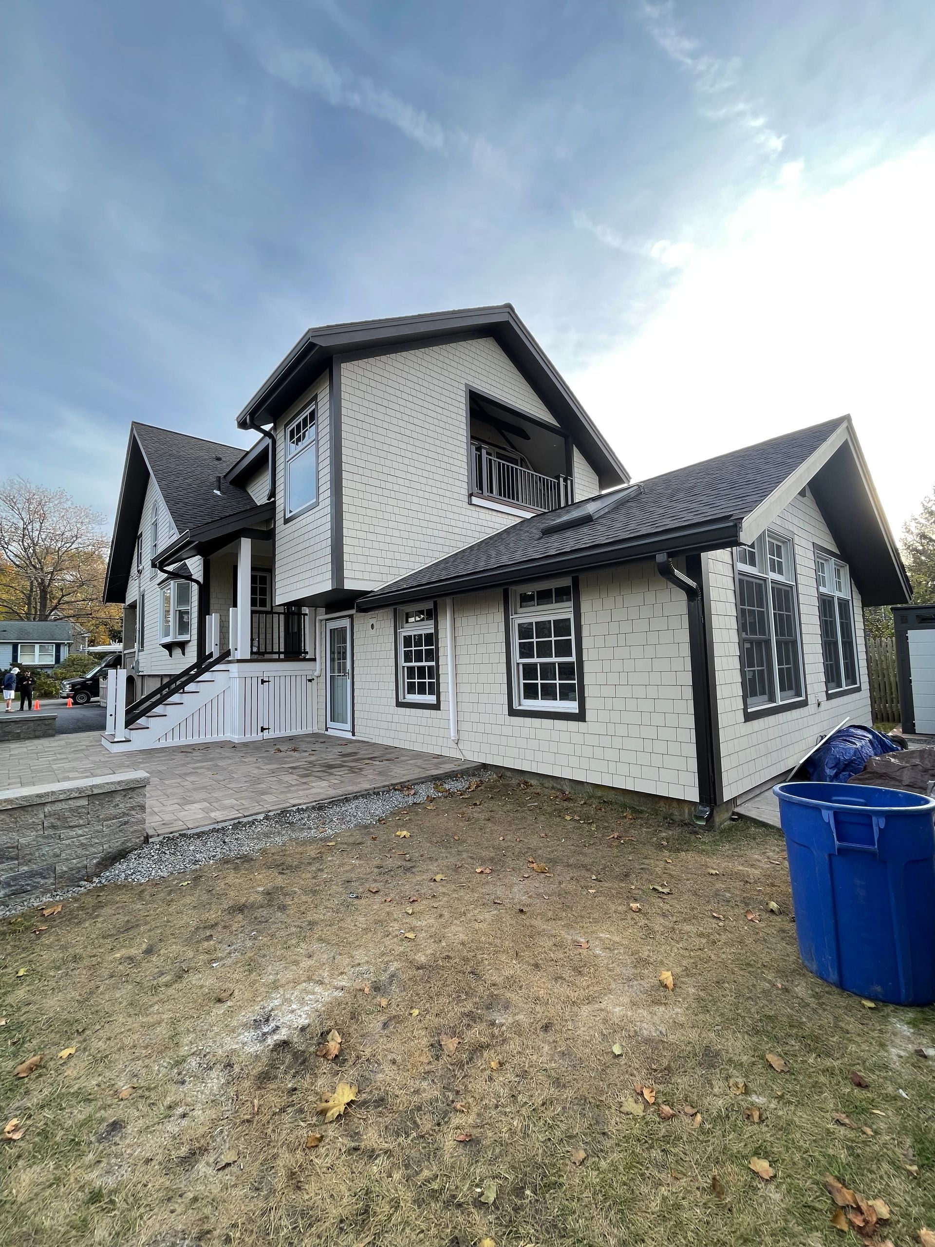 A close-up of a white gutter on the side of a house.