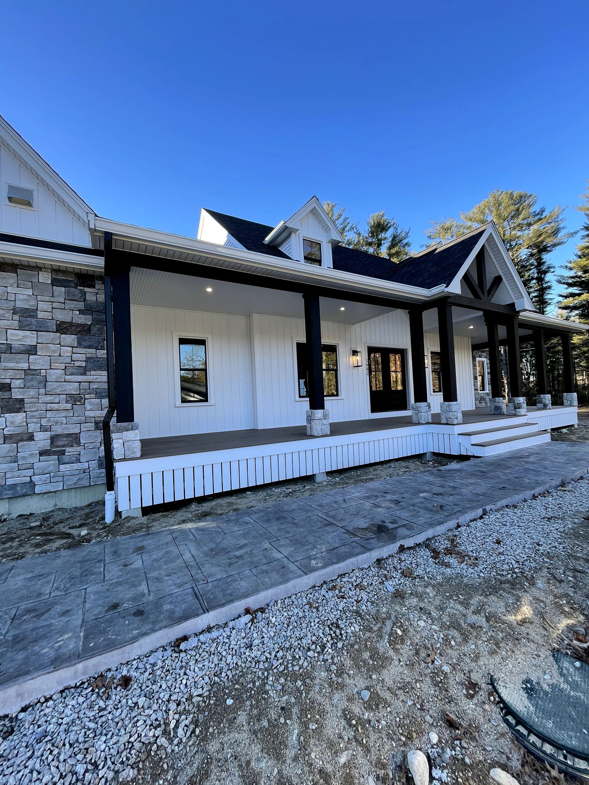 A wooden deck with a fence and trees in the background.