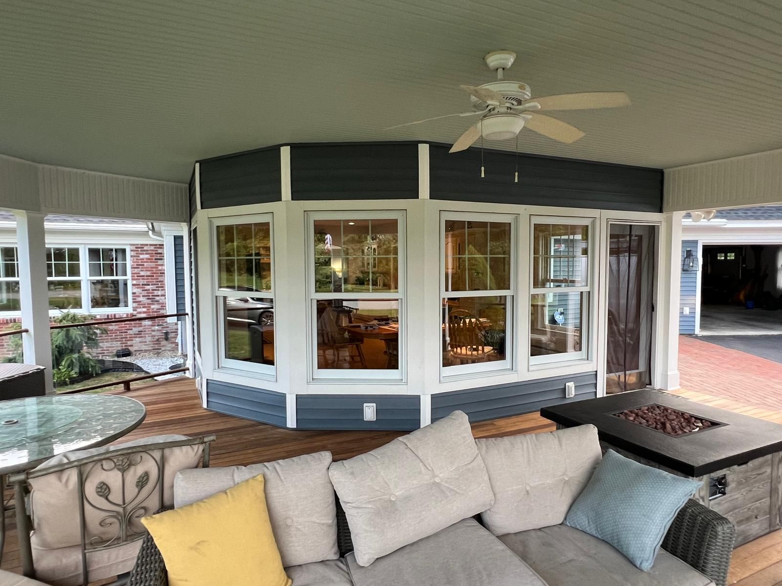 A living room with a lot of windows and french doors.