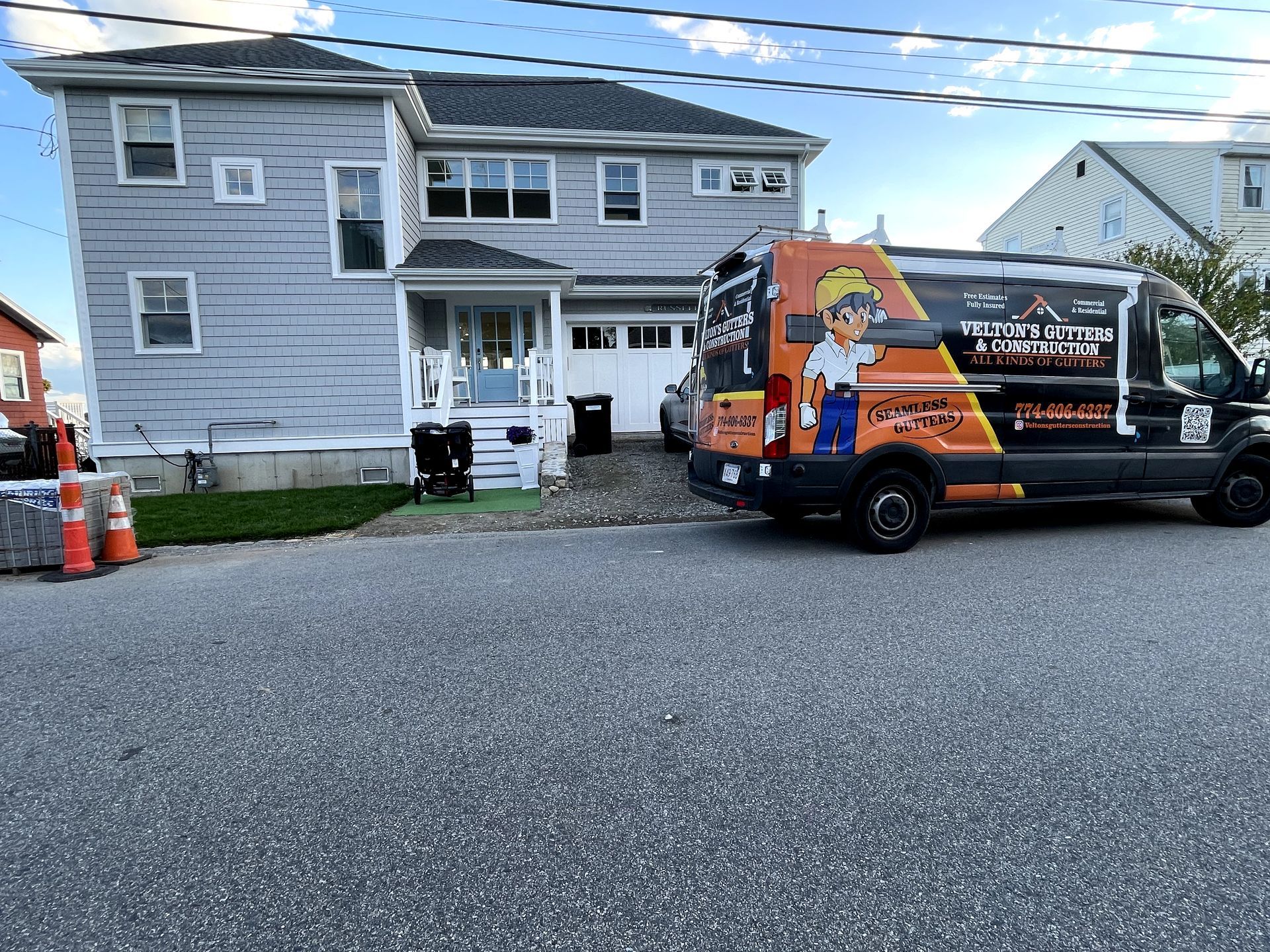 A brown roof of a house with a tree in the background.