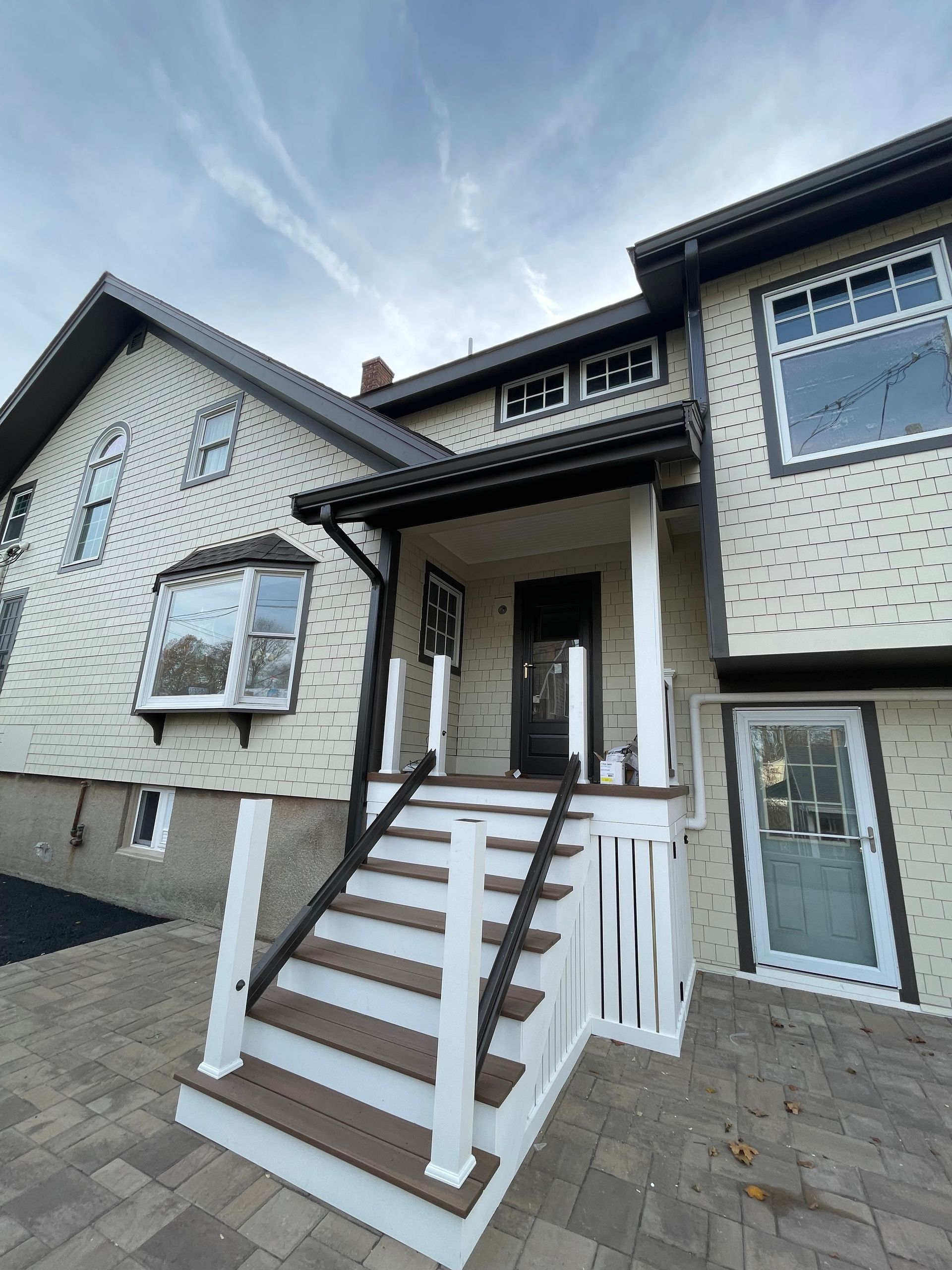 A person is fixing a gutter with a screwdriver.