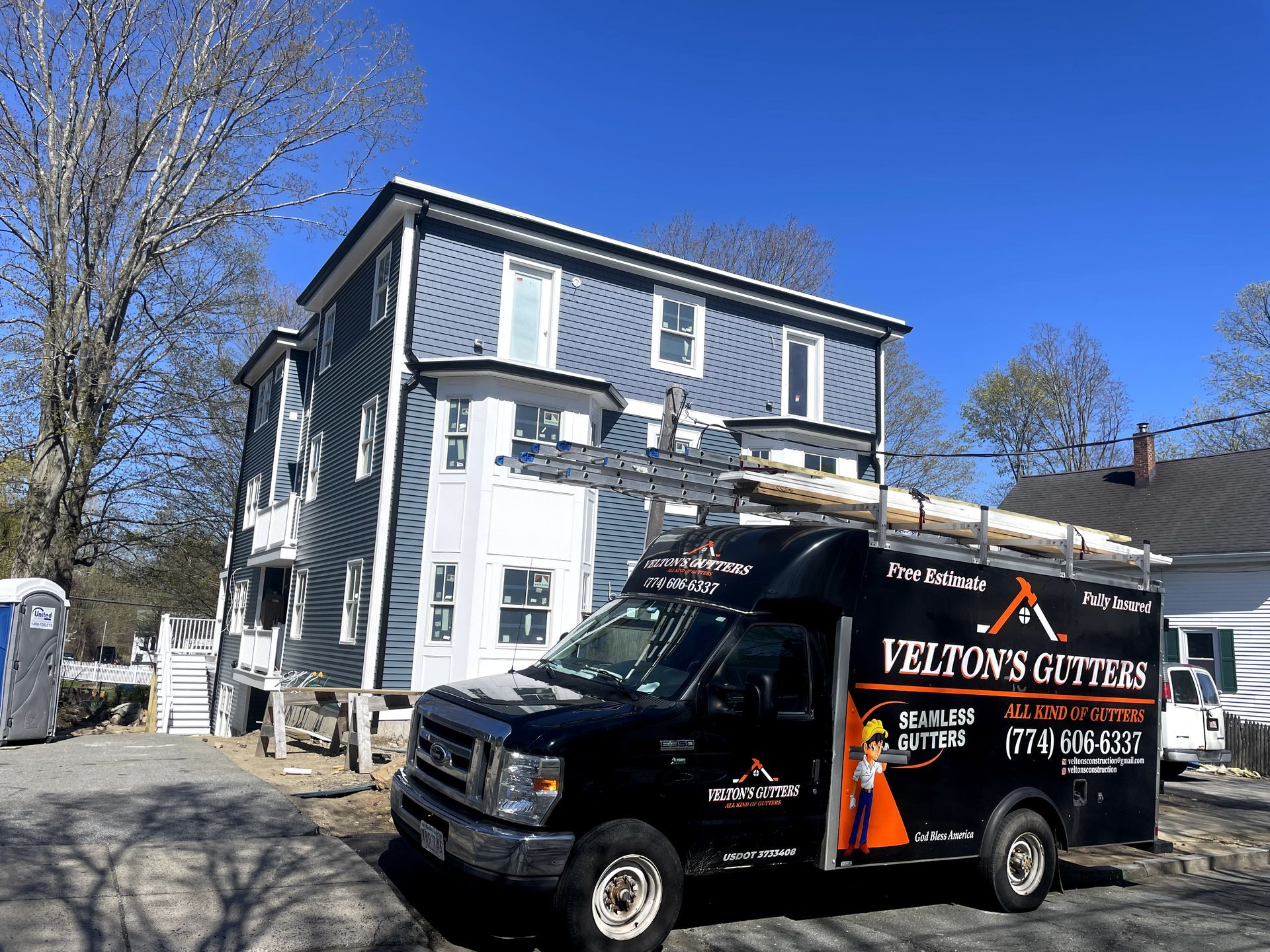 A large white house with a gray roof.