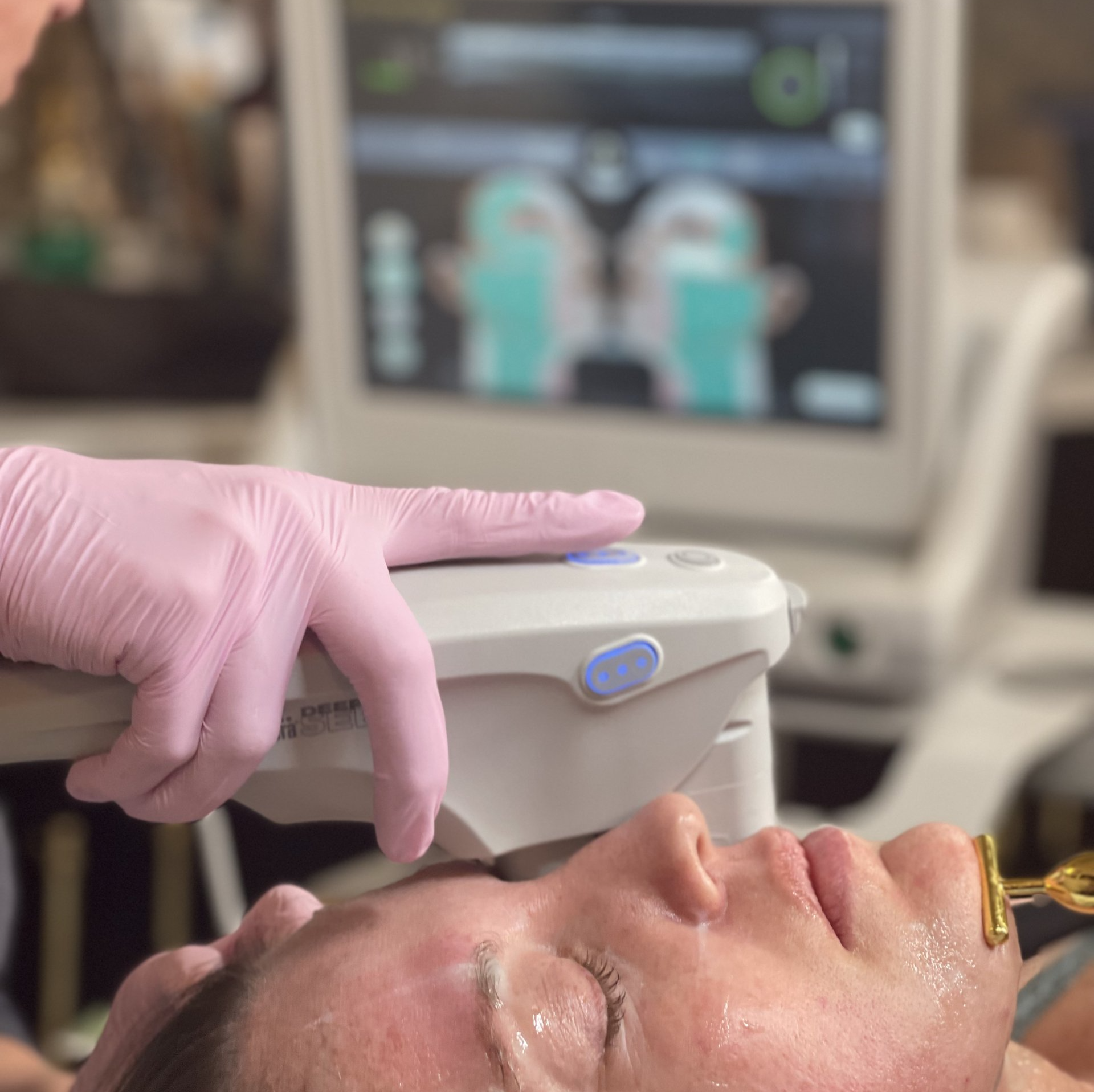 A woman is getting a facial treatment with a machine.