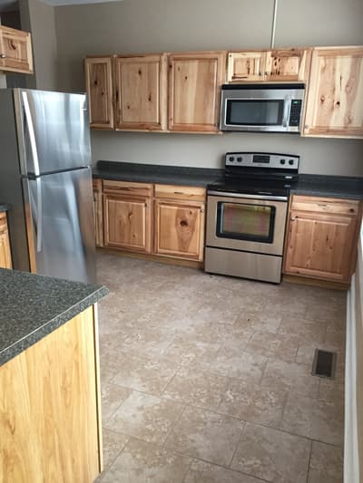 Kitchen with tile floors and stainless steel appliances