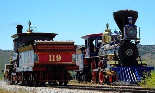 Two historic steam locomotives on tracks, one numbered 