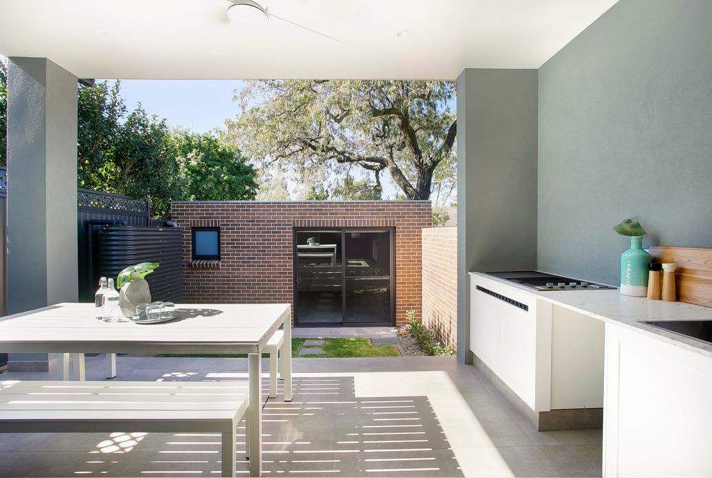 A kitchen with a table and benches in it