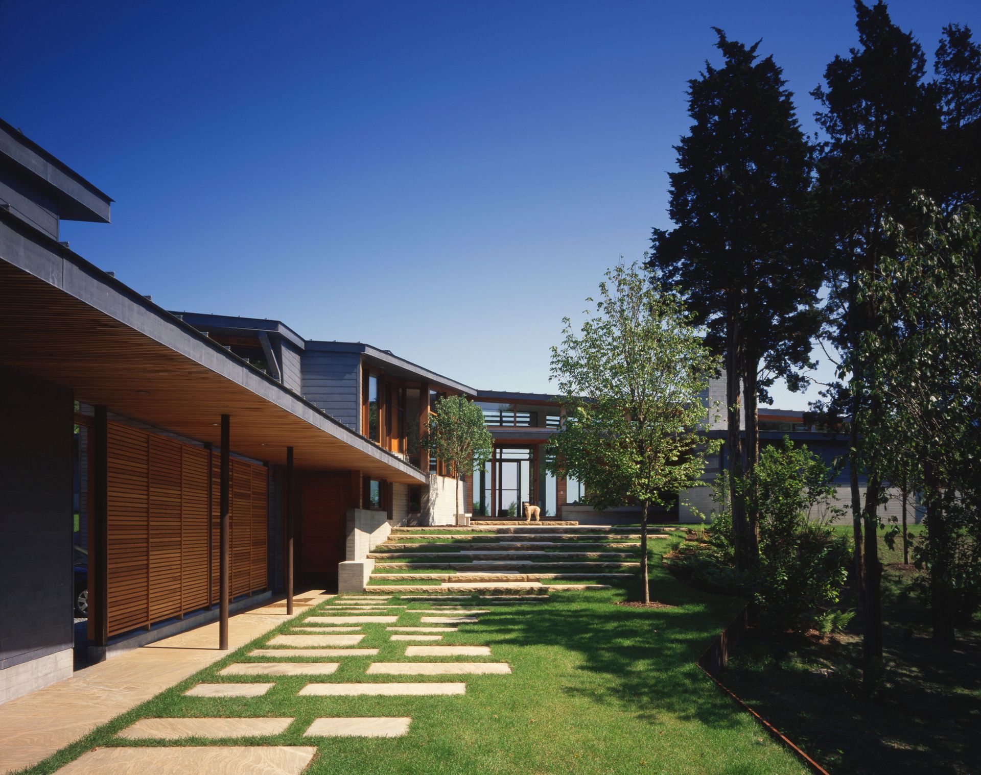 A large house with a lush green lawn in front of it
