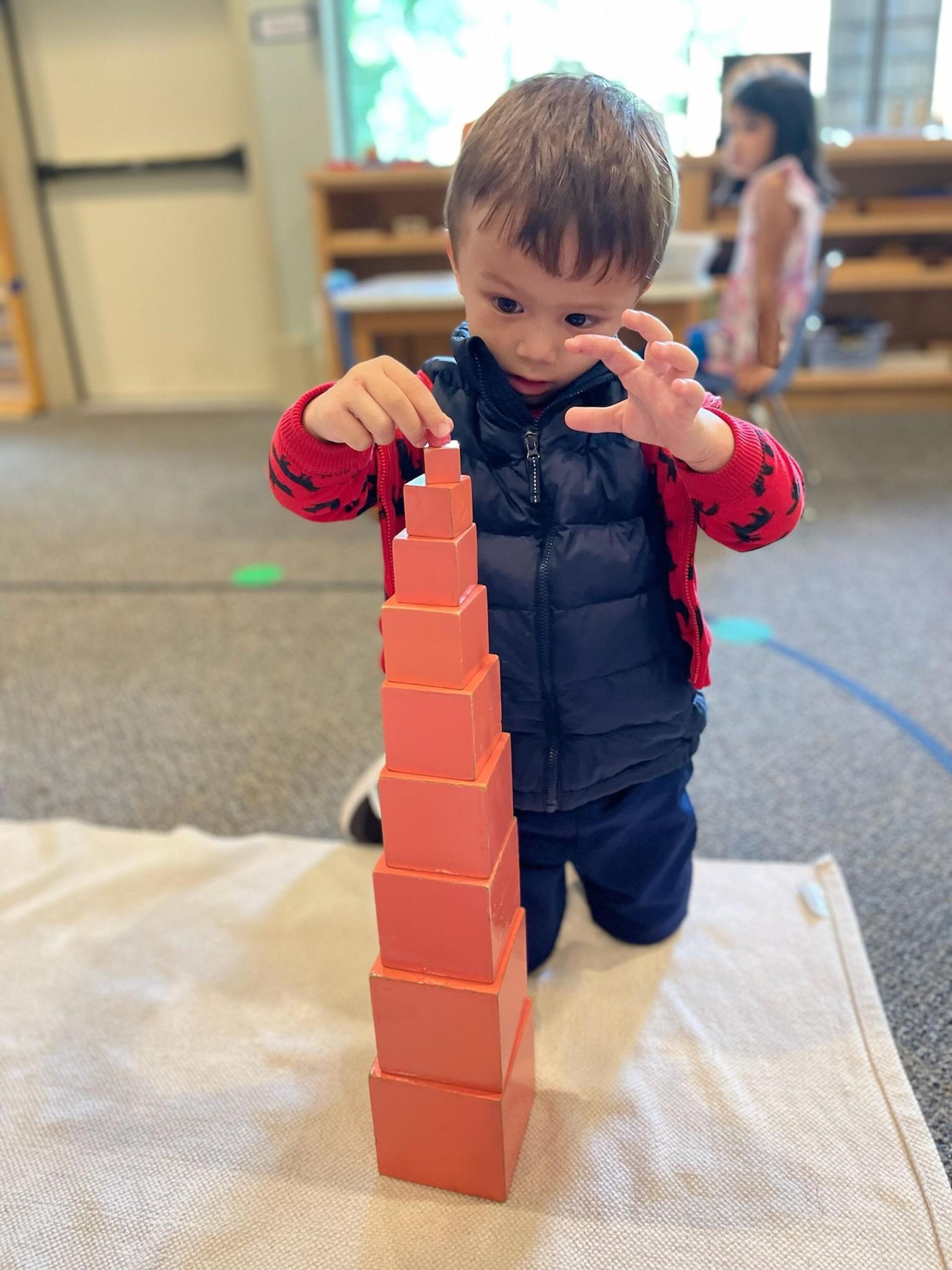 Child working with the Montessori Pink Tower