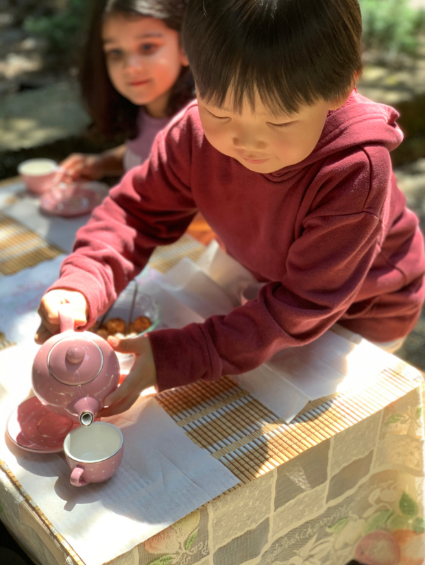 Child working on a Montessori Practical Life activity