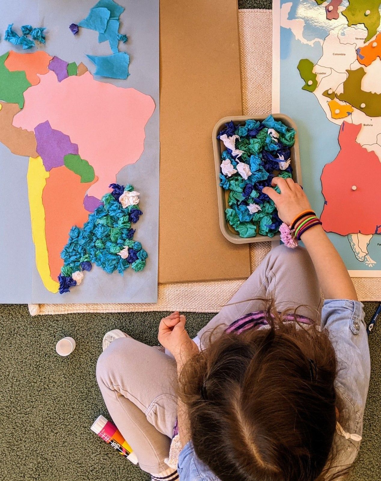 Child working with Montessori geography materials