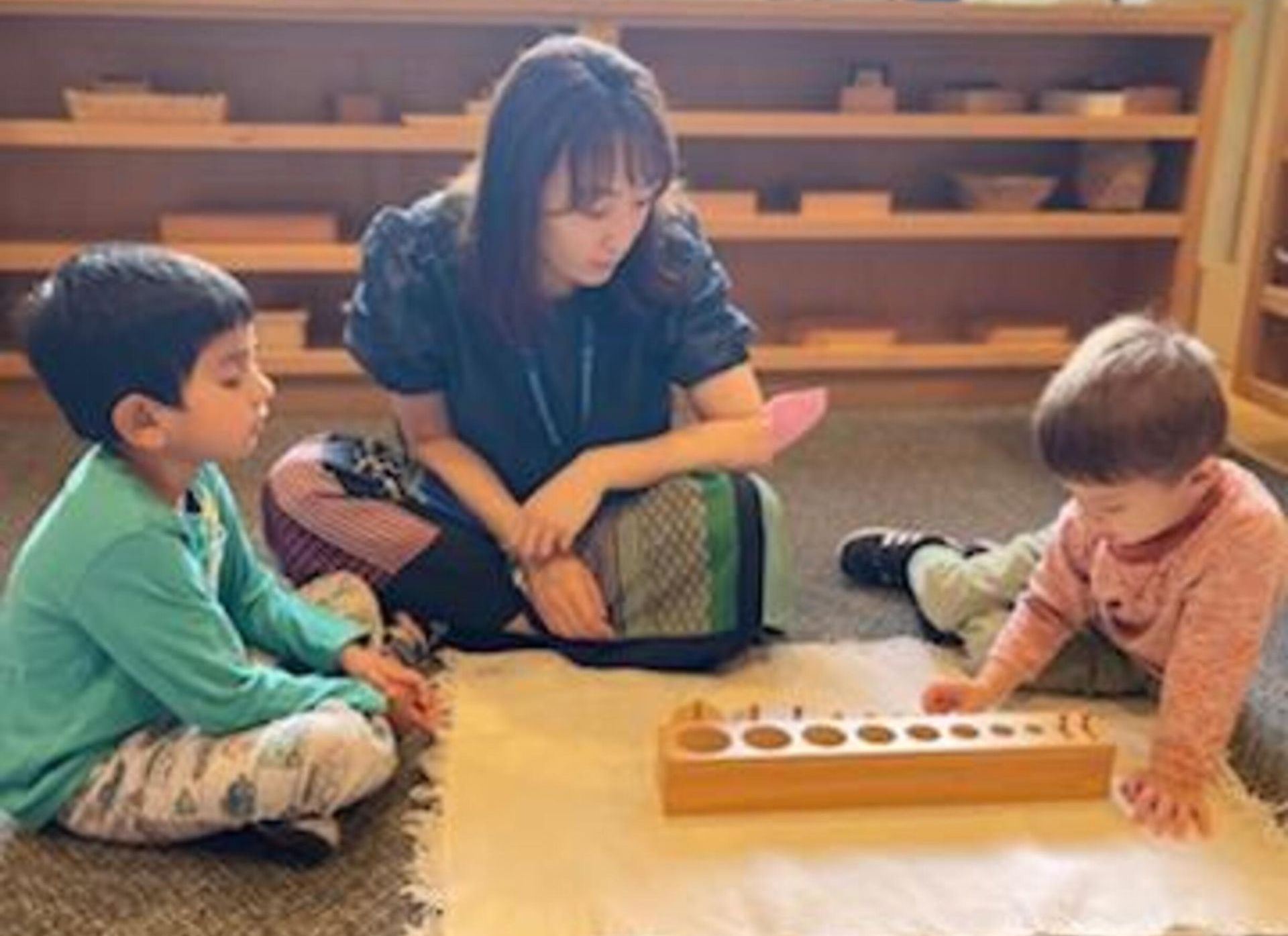 Children and guide in a Montessori classroom