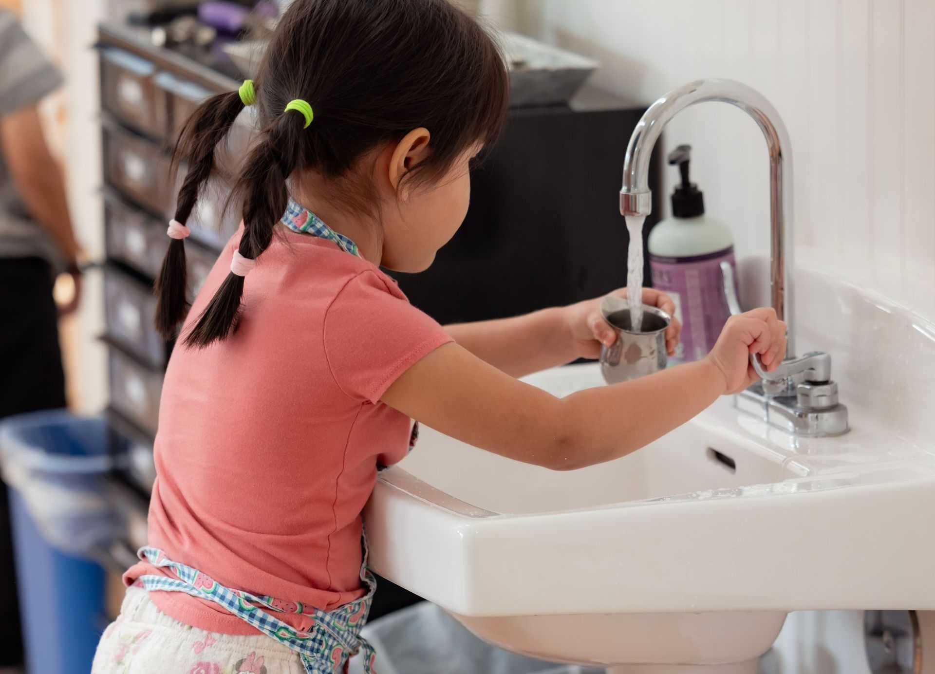 Toddler working on Montessori Practical Life skills