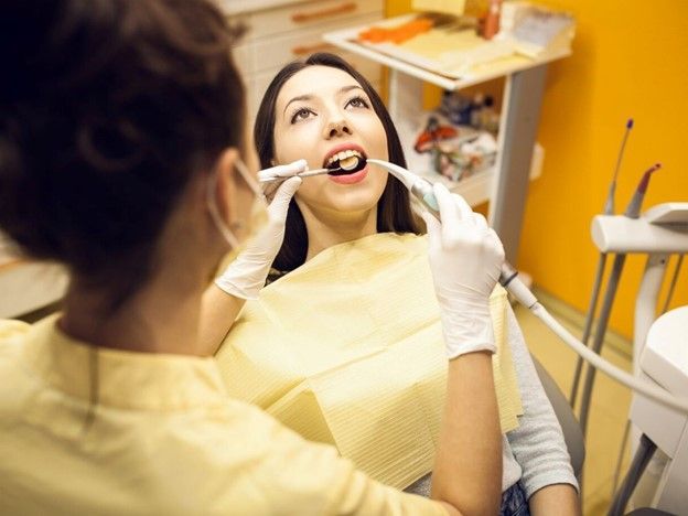 Woman getting dental exam