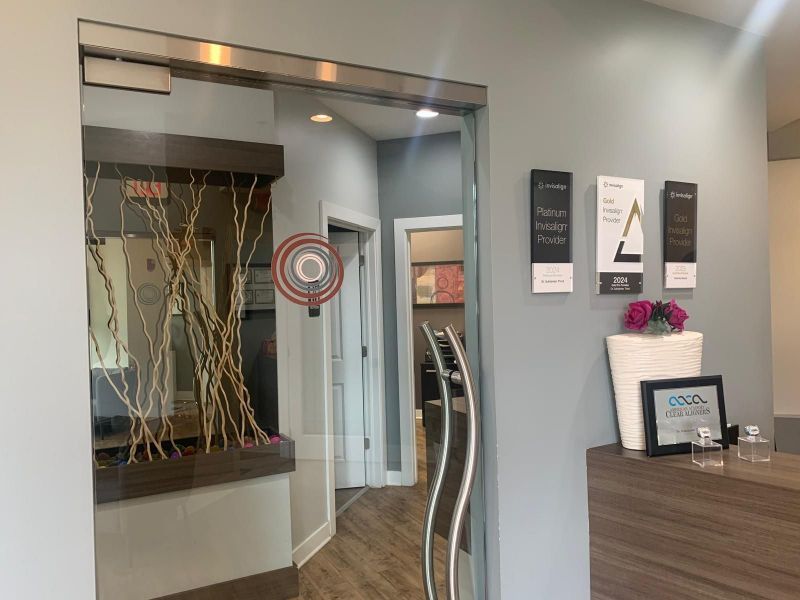 A dental office with a reception desk and a sliding glass door.
