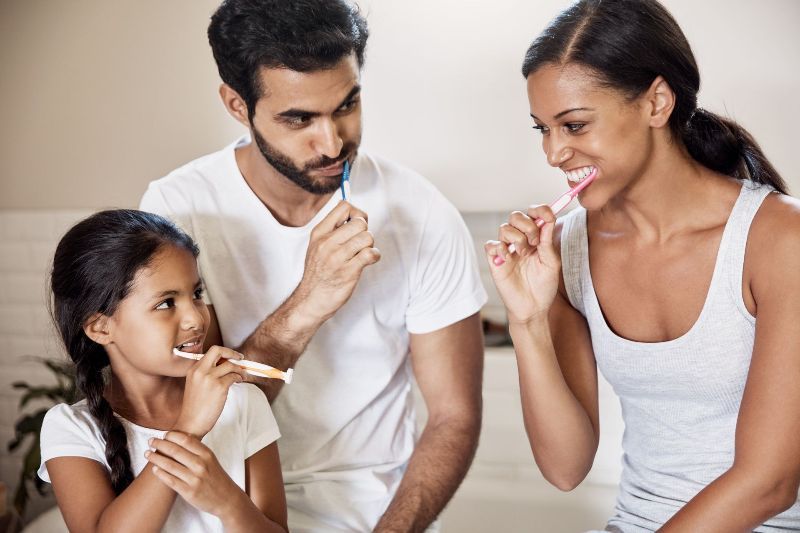 Family brushing their teeth