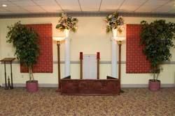 A room with a podium and candles in it.