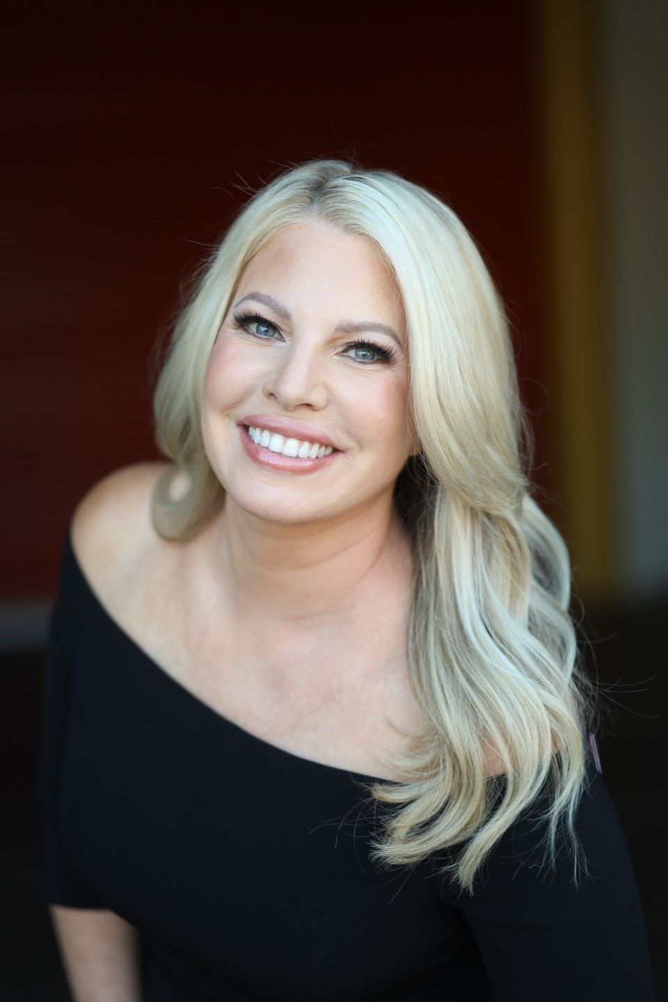 A man in a suit and tie stands next to a woman in a black dress